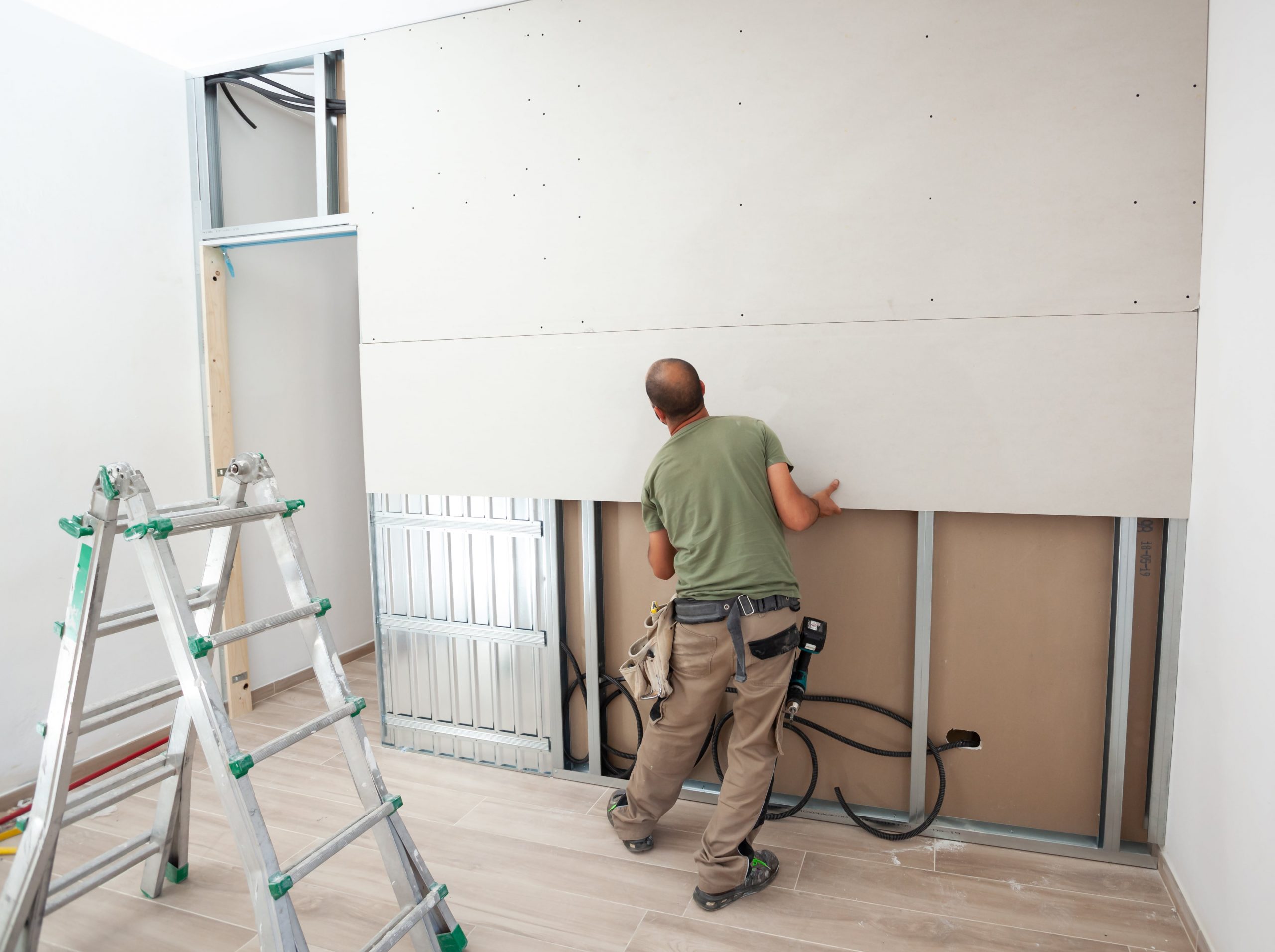 worker building plasterboard wall 2021 08 26 18 36 53 utc min scaled