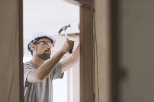 carpenter installing a door jamb at home 2021 08 26 22 39 57 utc min scaled 1